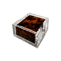Set of four tortoiseshell-patterned acrylic coasters stacked inside a clear square Lucite holder with polished transparent edges.