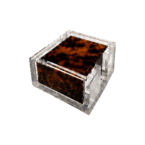 Set of four tortoiseshell-patterned acrylic coasters stacked inside a clear square Lucite holder with polished transparent edges.