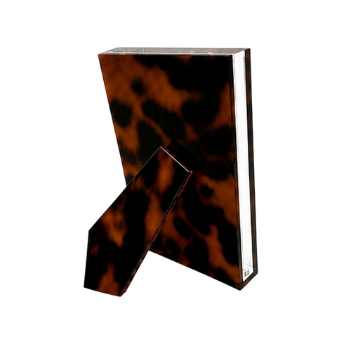 Acrylic Photo Frame in tortoiseshell-patterned Lucite shown from the back with a matching angled easel stand and clear beveled edges.
